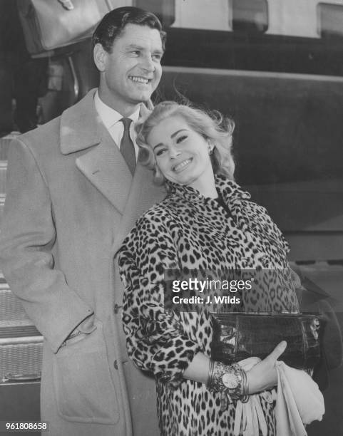 Swedish actress Anita Ekberg arrives at London Airport from Los Angeles with her husband, actor Anthony Steel , 23rd November 1957. They are both in...