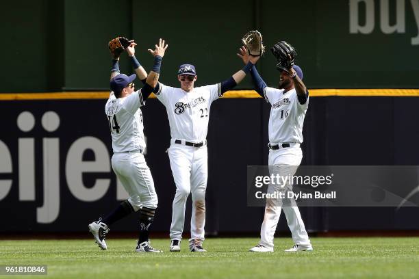 Hernan Perez, Christian Yelich, and Domingo Santana of the Milwaukee Brewers celebrate after beating the Arizona Diamondbacks 9-2 at Miller Park on...