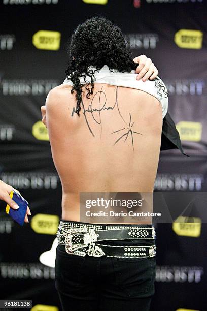 Michael Jackson impersonator Pete Carter shows the tattoo of Michael Jackson's autograph on his back during the Michael Jackson's 'This Is It'...