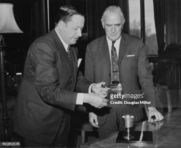 Gaston Thorn , the Foreign Minister of Luxembourg, receives two silver goblets from Michael Stewart , the British Foreign Secretary, at the Foreign...