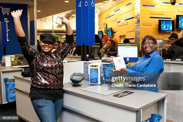 The first customer buys a copy of the DVD during Michael Jackson's 'This Is It' midnight madness DVD release celebration at Best Buy on January 25,...