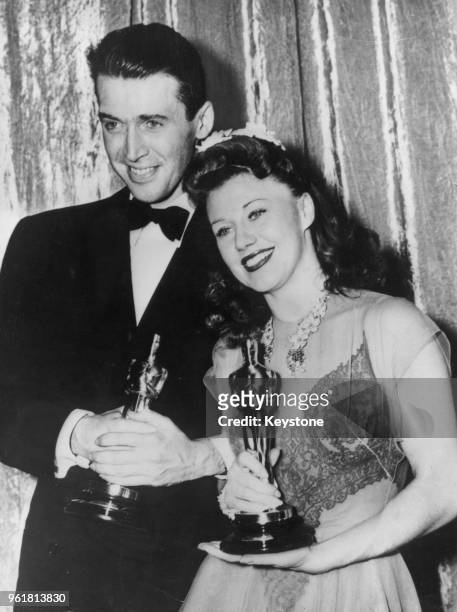 American actors James Stewart and Ginger Rogers with their awards for Best Actor in 'The Philadelphia Story' and Best Actress in 'Kitty Foyle' at the...
