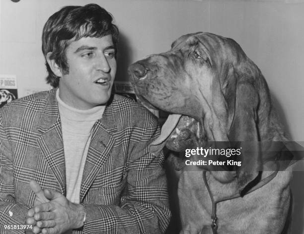 English disc jockey Ed 'Stewpot' Stewart of pirate radio station 'Radio London' visits the Canine Defence League stand at the Boys and Girls...