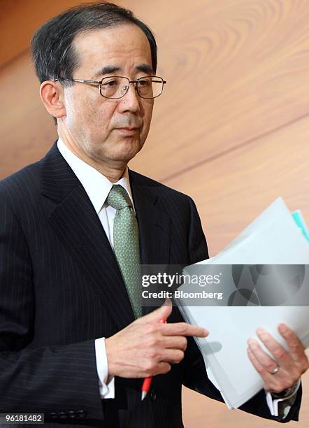 Masaaki Shirakawa, governor of the Bank of Japan, leaves a news conference at the central bank's headquarters in Tokyo, Japan, on Tuesday, Jan. 26,...