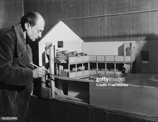 British theatre designer Richard Southern with his model of the Georgian Theatre Royal in Richmond, Yorkshire, on display at the British Drama League...