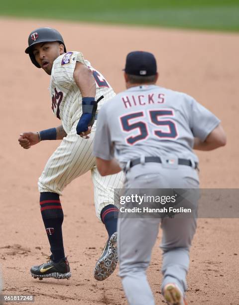 Eddie Rosario of the Minnesota Twins gets caught in a rundown between first and second base as John Hicks of the Detroit Tigers gives chase during...