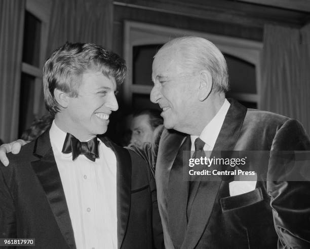 English entertainer Tommy Steele congratulates actor and writer Noël Coward after the opening night of Coward's play 'A Song at Twilight' at the...
