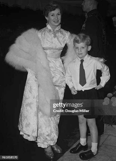 English actress Dinah Sheridan and her son Jeremy Hanley arrive at the Odeon Leicester Square in London for the Royal Film Performance of 'Where No...
