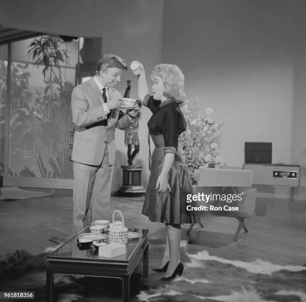 English actor and singer Tommy Steele and singer Marion Ryan film a musical routine for the movie 'It's All Happening' at Shepperton Studios in...