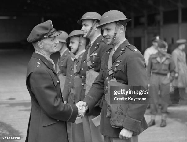 American Major-General Carl Andrew Spaatz , commander of the US Army Air Forces in Europe during World War II, decorates the crew of a Boston bomber...