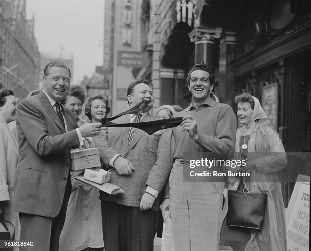 From left to right, Cyril Stapleton , Harry Secombe and Frankie Vaughan playing with a sock at the London Coliseum, during a rehearsal for that...