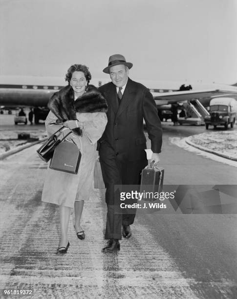 American actor James Stewart arrives at London Airport with his wife, actress and model Gloria Hatrick McLean , 12th January 1959. They will spend a...