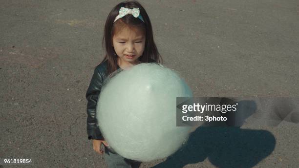 cute 3-4 years girl holding candy floss - city life in almaty stockfoto's en -beelden