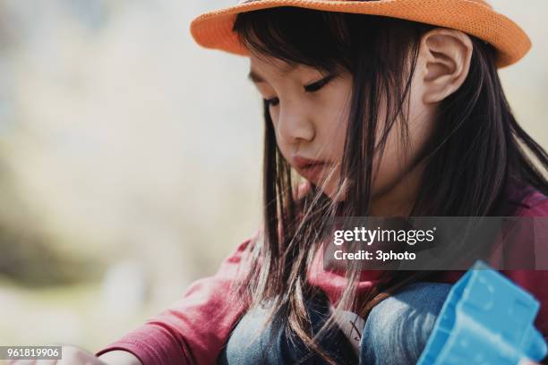 cute 3-4 years girl playing outdoors - city life in almaty stockfoto's en -beelden