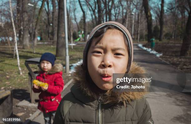 two sisters walking in the public park - city life in almaty stockfoto's en -beelden