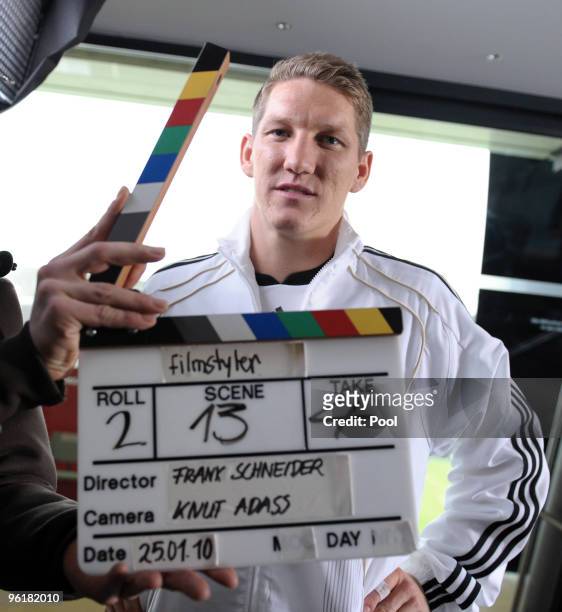 Bastian Schweinsteiger of Germany poses with a clapperboard during a record of a Mercedes Benz television advert for the FIFA Wolrd Cup 2010 at the...