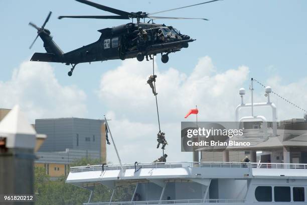 Special operators fast rope on to the deck of the StarShip cruise ship from a Black Hawk UH-60 helicopter while participating in an International...