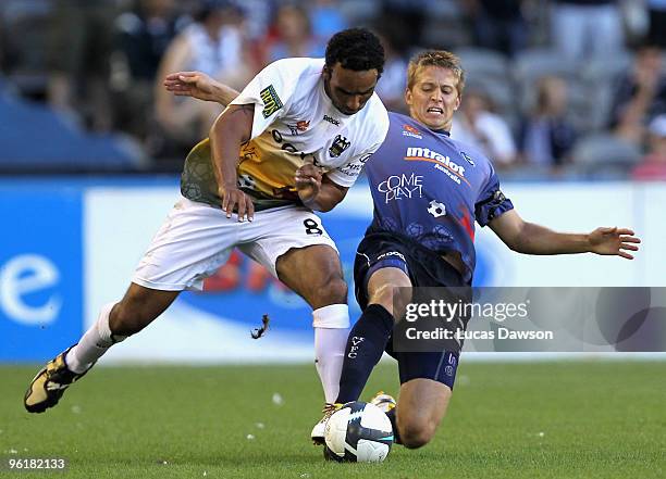 Paul Ifill of the Phoenix competes with Adrian Lejer of the Victory during the round 19 A-League match between the Melbourne Victory and the...