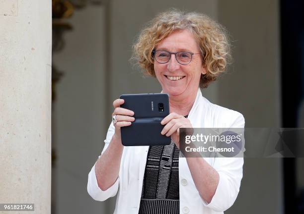 French Labour Minister Muriel Penicaud takes a picture as she leaves the Elysee Presidential Palace after a weekly cabinet meeting on May 23, 2018 in...