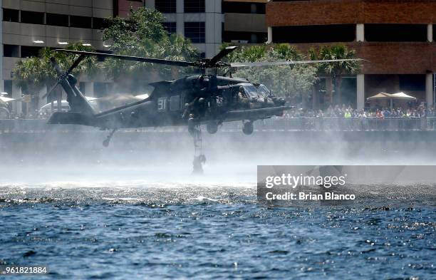 Spectators look on as a Black Hawk UH-60 helicopter recovers special operators from Tampa Bay during an International Special Operations Forces...