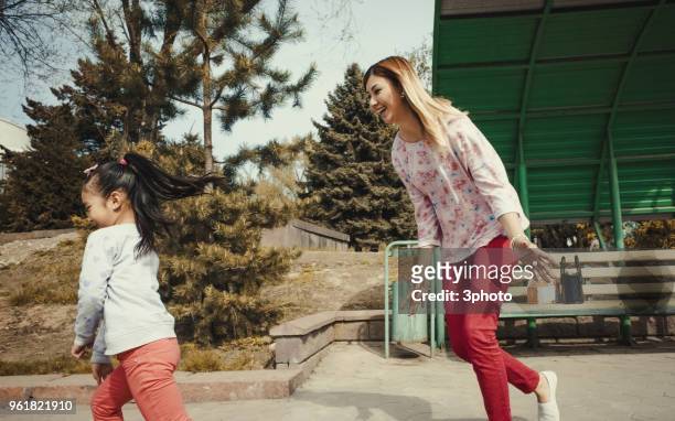mother and daughter playing in the city - city life in almaty stockfoto's en -beelden