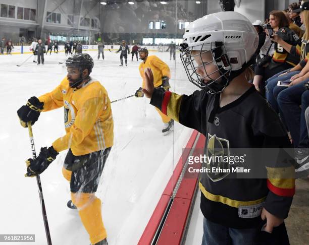 Jacob Kotter of Nevada watches Vegas Golden Knights players, including Pierre-Edouard Bellemare and Ryan Reaves, hold their first practice since...