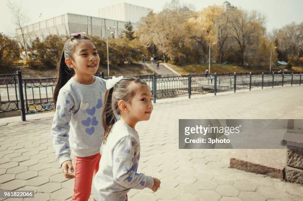 two sisters playing in the city - city life in almaty stockfoto's en -beelden