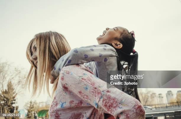 mother and daughter having fun together - city life in almaty stockfoto's en -beelden