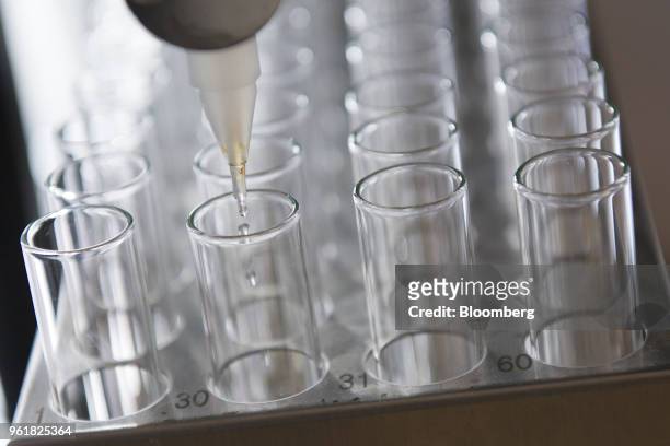 An automated machine works on purification of potential hepatitis C virus drug candidate at the Gilead Sciences Inc. Lab in Foster City, California,...