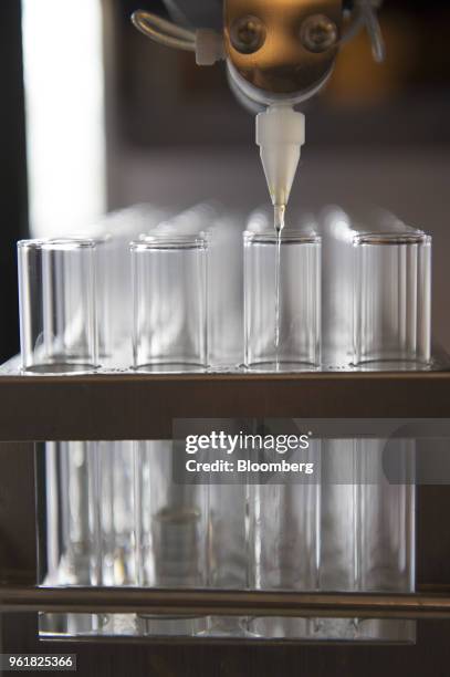 An automated machine works on purification of potential hepatitis C virus drug candidate at the Gilead Sciences Inc. Lab in Foster City, California,...