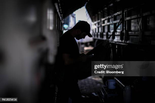 Truck driver stands next to a truck parked on BR 040 highway during a protest against rising fuel prices in Luziania, Brazil, on Wednesday, May 23,...