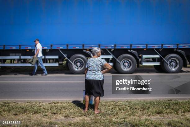 Woman stands in front of a truck parked on BR 040 highway during a protest against rising fuel prices in Luziania, Brazil, on Wednesday, May 23,...