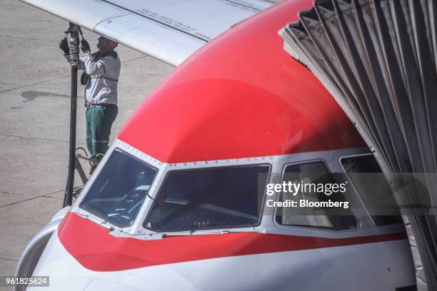 Petroleo Brasileiro SA worker refuels a plane at Brasilia-Presidente Juscelino Kubitschek International Airport in Brasilia, Brazil, on Wednesday,...