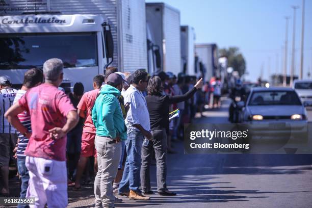 Truck driver gives a thumbs up while gathering on BR 040 highway during a protest against rising fuel prices in Luziania, Brazil, on Wednesday, May...