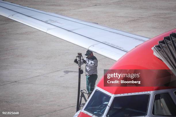 Petroleo Brasileiro SA worker refuels a plane at Brasilia-Presidente Juscelino Kubitschek International Airport in Brasilia, Brazil, on Wednesday,...