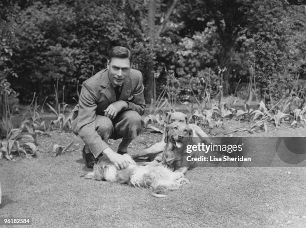 George VI, , King of Great Britain, with his dogs in the grounds of the Royal Lodge, Windsor, June 1936.