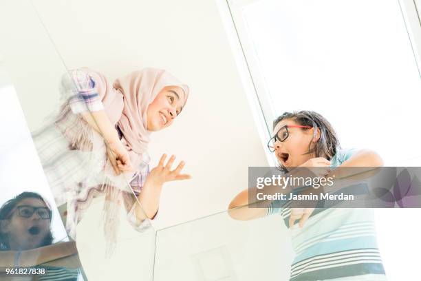 muslim teenage girl and boy having fun - two young arabic children only indoor portrait stock pictures, royalty-free photos & images