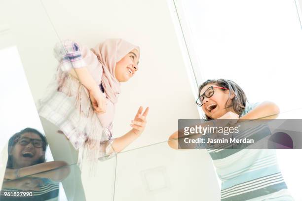 muslim teenage girl and boy having fun - two young arabic children only indoor portrait stock pictures, royalty-free photos & images