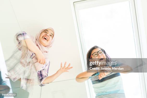 muslim teenage girl and boy having fun - two young arabic children only indoor portrait stock pictures, royalty-free photos & images