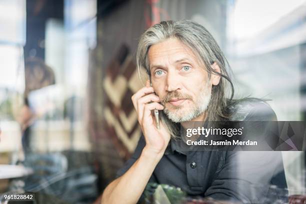 Man sitting in coffeeshop and using smart phone