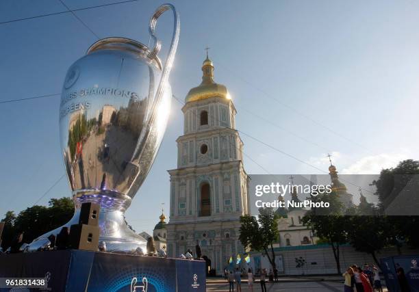 People walk next of a giant replica of the UEFA Champions League trophy in center of Kiev, Ukraine, 23 May, 2018.Kiev is preparing for the 2018 UEFA...