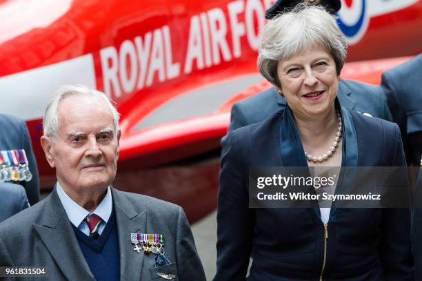 British Prime Minister Theresa May and WW2 pilot Colin Bell pose for a photo with a group of RAF personnel next to a life-sized replica of Red Arrows...