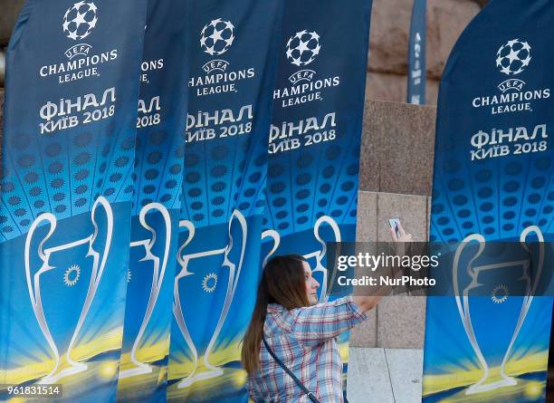 Woman takes a selfie in front of the flags with the UEFA Champions League final logo in central in Kiev, Ukraine, 23 May, 2018. Kiev is preparing for...