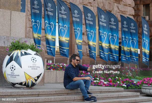 Man poses for a selfie in front of the ball and flags with the UEFA Champions League final logo in central in Kiev, Ukraine, 23 May, 2018. Kiev is...