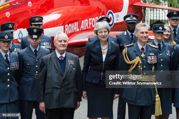 British Prime Minister Theresa May , WW2 pilot Colin Bell and Air Chief Marshal Stephen Hillier pose for a photo with a group of RAF personnel next...