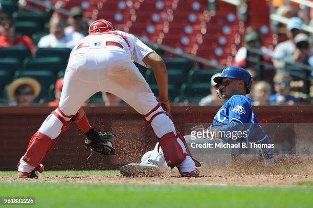 Ryan Goins of the Kansas City Royals is tagged out at home by Francisco Pena of the St. Louis Cardinals at Busch Stadium on May 23, 2018 in St....