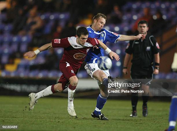 Ryan Gilligan of Northampton Town contests the ball with Paul Bolland of Macclesfield Town during the Coca Cola League Two Match between Macclesfield...