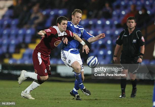 Ryan Gilligan of Northampton Town contests the ball with Paul Bolland of Macclesfield Town during the Coca Cola League Two Match between Macclesfield...