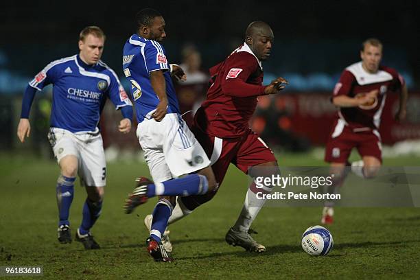 Adebayo Akinfenwa of Northampton Town looks to move past the challenge of Nat Brown of Macclesfield Town during the Coca Cola League Two Match...