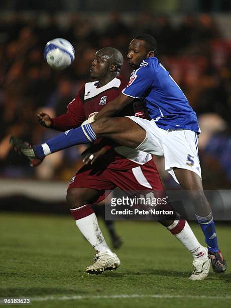 Adebayo Akinfenwa of Northampton Town looks to control the ball under pressure from Nat Brown of Macclesfield Town during the Coca Cola League Two...